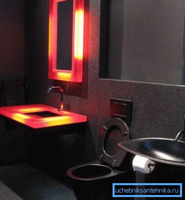 Čierne WC na toalete, ktoré je vyzdobené v štýle hi-tech Čierne WC na toalete, ktoré je vyzdobené v štýle hi-tech